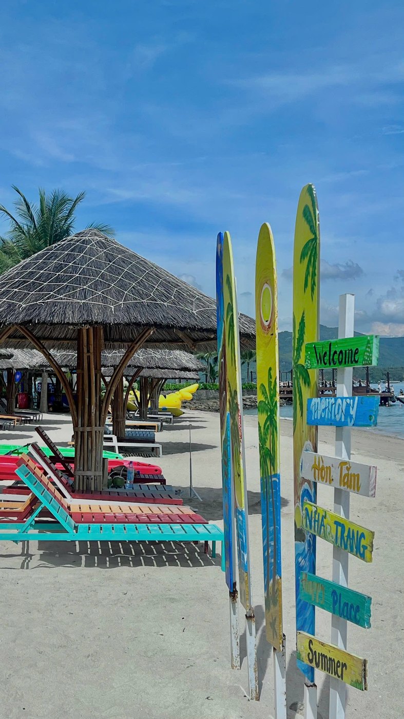Hon Tam beach area with signs and loungers